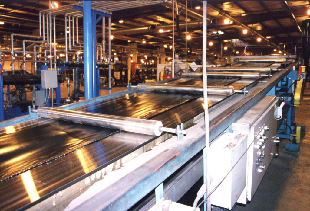 Industrial manufacturing facility with conveyor belts and machinery.